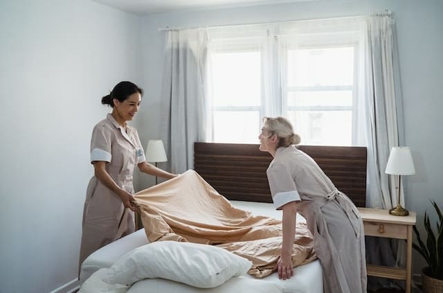 housekeepers making bed in home